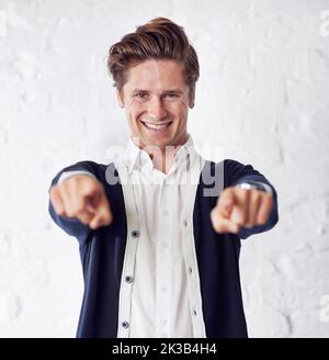 Its all you. A handsome young man pointing towards the camera. Stock Photo