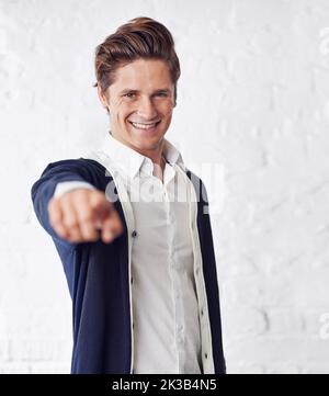 Its all you. A handsome young man pointing towards the camera. Stock Photo