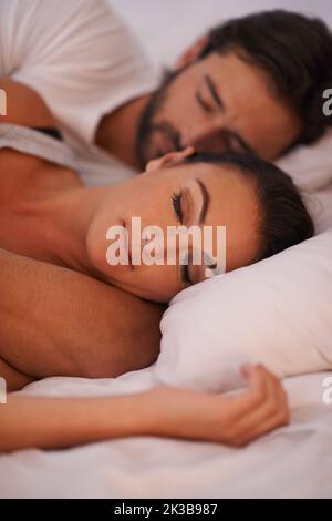 Getting a peaceful night of rest. A couple sleeping in their bed. Stock Photo