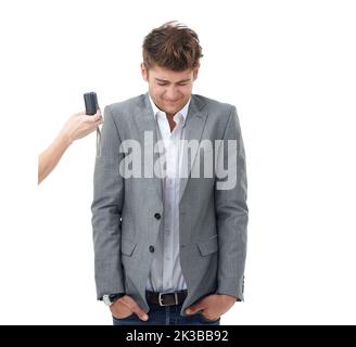 Somebody is shy. Studio shot of a young man wincing in front of a camera isolated on white. Stock Photo