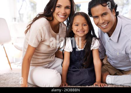 Family over everything. Cropped portrait of an affectionate young family at home. Stock Photo