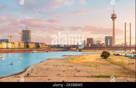 Panoramic view of Rheinkniebrucke Bridge and Tv tower in Dusseldorf city and transportation water way of the whole Germany - Rhine River, along which Stock Photo