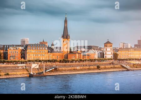 Recognizable architectural towers of the city of Dusseldorf and transportation waterway of the whole of Germany - the Rhine River Stock Photo