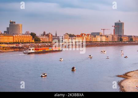 22 July 2022, Dusseldorf, Germany: Urban panoramic cityscape view of old town and transportation waterway of the whole of Germany - the Rhine River, a Stock Photo