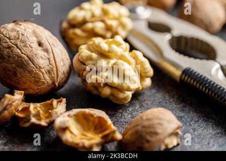 Peeled walnut on the dark table. Stock Photo