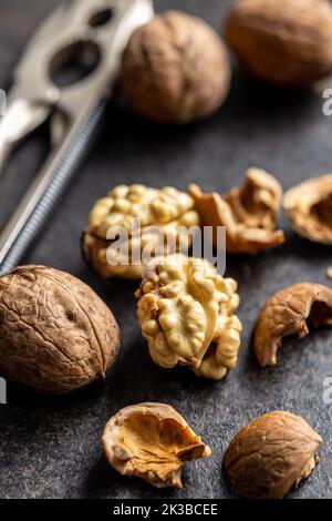 Peeled walnut on the dark table. Stock Photo
