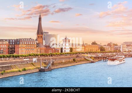 Recognizable architectural towers of the city of Dusseldorf and transportation waterway of the whole of Germany - the Rhine River, along which large b Stock Photo