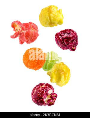 Falling Colored fruity popcorn isolated on white background, clipping path, full depth of field Stock Photo