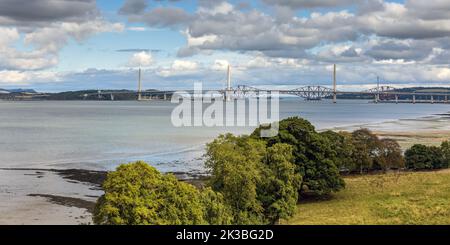View along the Forth River near Edinburgh in Scotland, with the three Forth bridges in the distance. Stock Photo