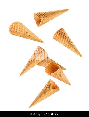 Falling Empty ice cream cone, isolated on white background, clipping path, full depth of field Stock Photo