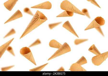 Falling Empty ice cream cone, isolated on white background, selective focus Stock Photo