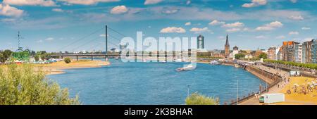 23 July 2022, Dusseldorf, Germany: Recognizable architectural towers of the city of Dusseldorf and transportation waterway of the whole of Germany - R Stock Photo