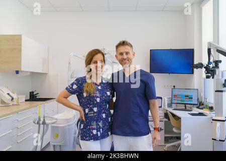 Dentist posing with nurse in dentists ambulance. Stock Photo