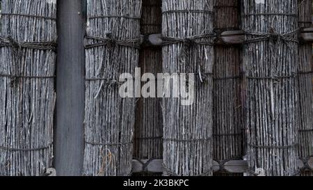 Decorative hedge of bunches of dry rods and tree branches Stock Photo