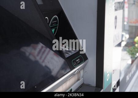 Atm machine from side view, black automatic teller machine, business and finance concept, atm with screen, money withdraw and paying idea Stock Photo