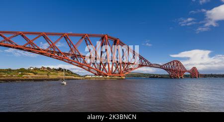 The mighty Forth rail bridge spreading across the Firth of Forth connecting north and south Queensferry in Scotland. Taken from North Queensferry. Stock Photo