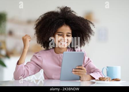 Happy african american preteen girl playing video game Stock Photo