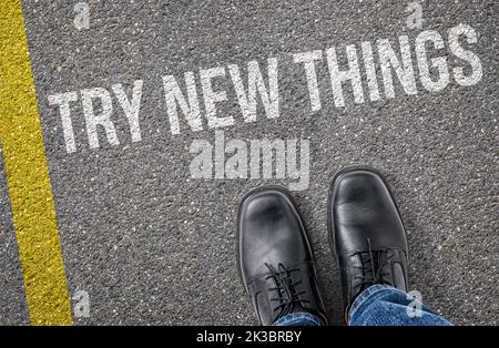 Text on the road - Try new things Stock Photo