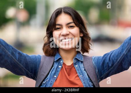 Closeup Shot Of Beautiful Young Middle Eastern Female Student Taking Selfie Outdoors Stock Photo