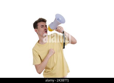 Young caucasian man shouting through megaphone, isolated. Stock Photo