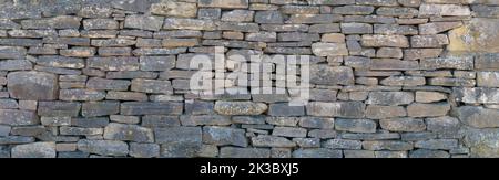 Grey dry stone wall texture. Stock Photo