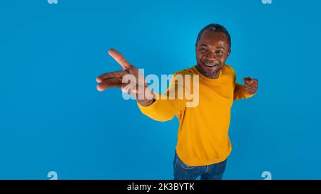 Cheerful black man showing something on his hand Stock Photo