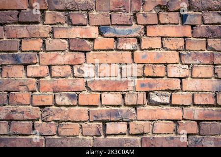Red old worn brick wall background. Vintage effect. Abstract pattern of bricks. Grunge concrete backdrop. Brown cement texture. Construction material Stock Photo