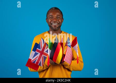 Middle-aged african american man holding various flags Stock Photo