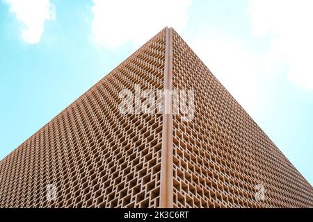 Minimal and abstract architectural structure with open sky, symmetrical design, square pattern and modern building, orange pastel tones Stock Photo