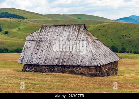 Abandoned old shepherd cottage on pasture land hill in Zlatibor region in Serbia Stock Photo