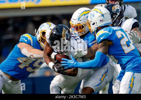 Jacksonville Jaguars running back Travis Etienne Jr. (1) runs the ball  during an NFL wild-card football game against the Los Angeles Chargers,  Saturday, Jan. 14, 2023, in Jacksonville, Fla. The Jaguars defeated