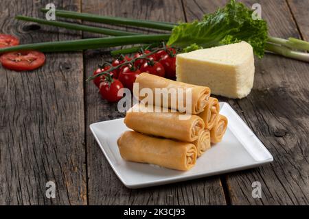 Fried spring rolls with sweet chili sauce and lime on plate Stock Photo