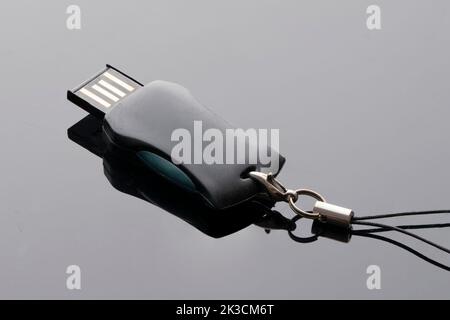 usb flash drive for computer folding on a black background close-up. Stock Photo