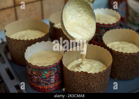 Preparation and filling of forms for baking Easter cakes Stock Photo