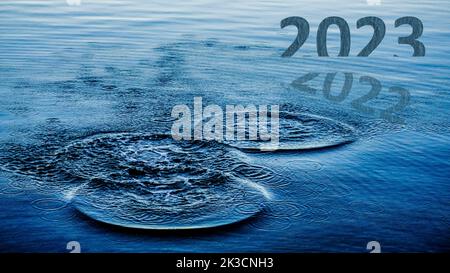 Happy New Year 2023 is coming. Transition from 2022 to new year 2023 concept, text on sea. High resolution photo for website banner, social media post