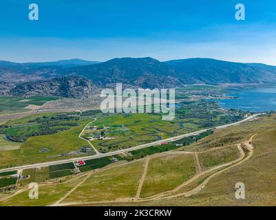 Drone view of Osoyoos town in Okanagan Valley region of British Columbia, Canada. It's surrounded by desert, vineyards, lake and mountains. Stock Photo