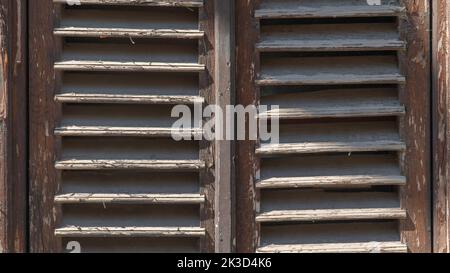 Old dilapidated wooden shutters it in the form of a lattice Stock Photo