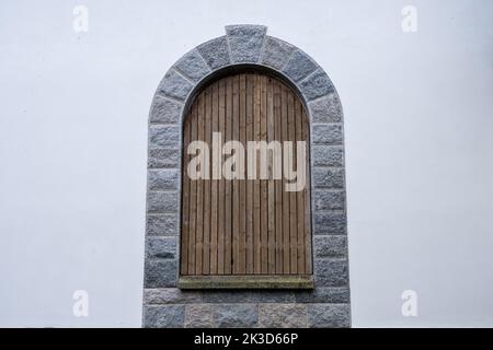 Old, boarded up window in the ruined wall of an old manor house in Latvia Stock Photo