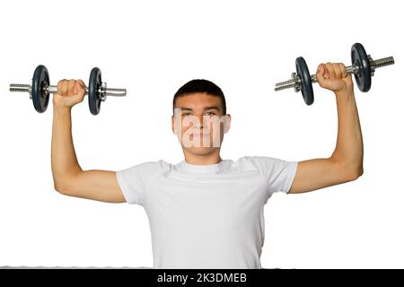 19 year old teenage boy lifting dumbbells Stock Photo