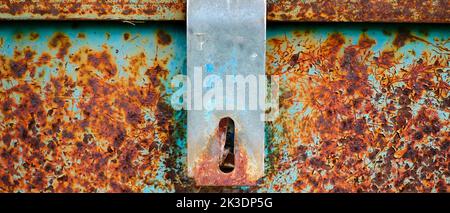 Detail of old rusty hinge on metal box for security Stock Photo