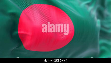 Close-up view of the Bangladesh national flag waving in the wind. People Republic of Bangladesh, is a country in South Asia. Fabric textured backgroun Stock Photo