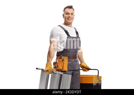 Repairman in a uniform carrying a ladder and a tool box isolated on white background Stock Photo