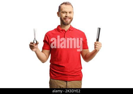 Man holding scissors and a hair comb isolated on white background Stock Photo