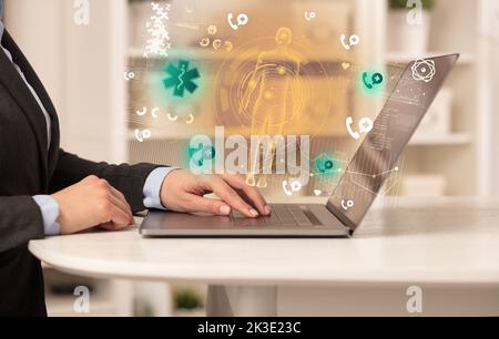 Doctor working on laptop with healthcare concept Stock Photo