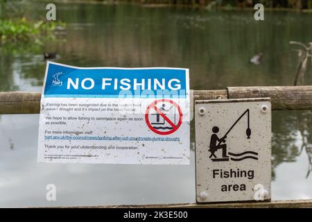 No fishing sign at a fishing area at Fleet Pond in summer 2022 due to low water levels caused by drought and heatwaves, Hampshire, England, UK Stock Photo