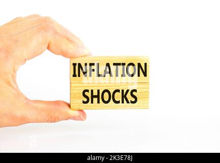 Inflation shocks symbol. Concept words Inflation shocks on wooden blocks. Beautiful white table white background. Businessman hand. Business inflation Stock Photo