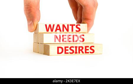 Wants needs and desires symbol. Concept words Wants Needs Desires on wooden blocks. Businessman hand. Beautiful white background. Business, psychologi Stock Photo