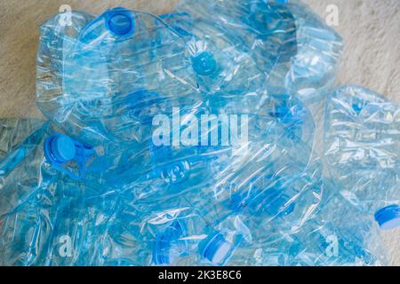 Large stack of old plastic bottles on the floor Stock Photo
