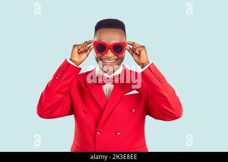Funny young African American man in red suit for work host of entertainment event or party Stock Photo