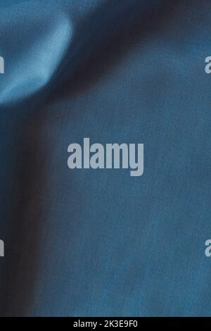 Abstract crumpled linen fabric texture background. Natural blue color dyed linen organic eco textiles canvas background. Top view Stock Photo